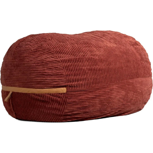 The Fuf XXL Foam Filled Bean Bag Chair in Deep Terracotta features a 6-foot oval shape, plush corded fabric, and a tan zipper along one side.