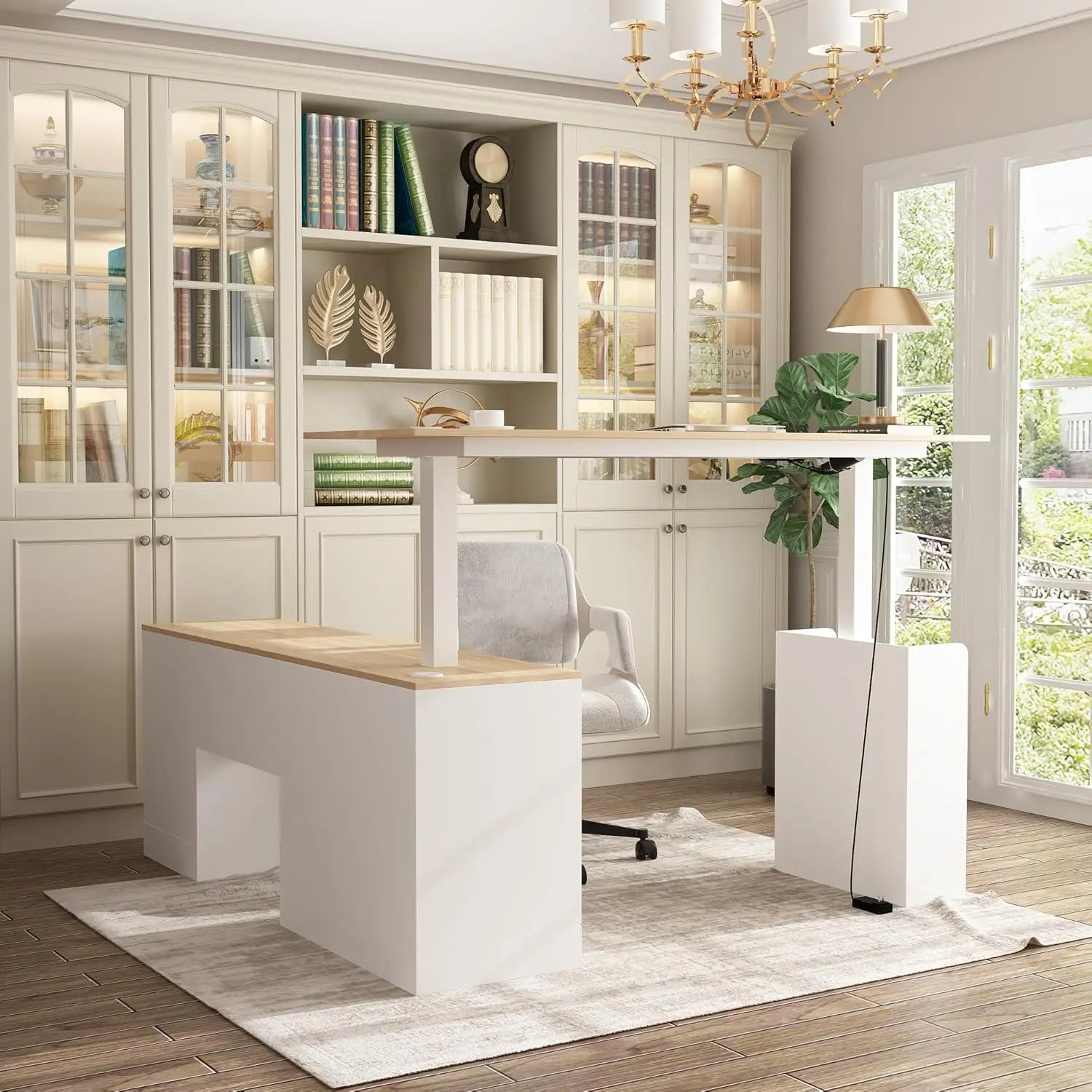 A bright, modern home office with a walnut and white L Shaped Electric Standing Desk with Drawers and Shelves, an ergonomic chair, a glass-door bookshelf, a lamp, and natural light streaming onto a light rug.