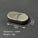 The Target Push Slider Fidget Slider Toy Metal EDC rests on a textured surface, featuring rounded edges, 50mm (1.97in) by 25mm (0.98in) size, 13mm thickness, and weighing 90g. Arrows indicate its length and width in mm and inches.