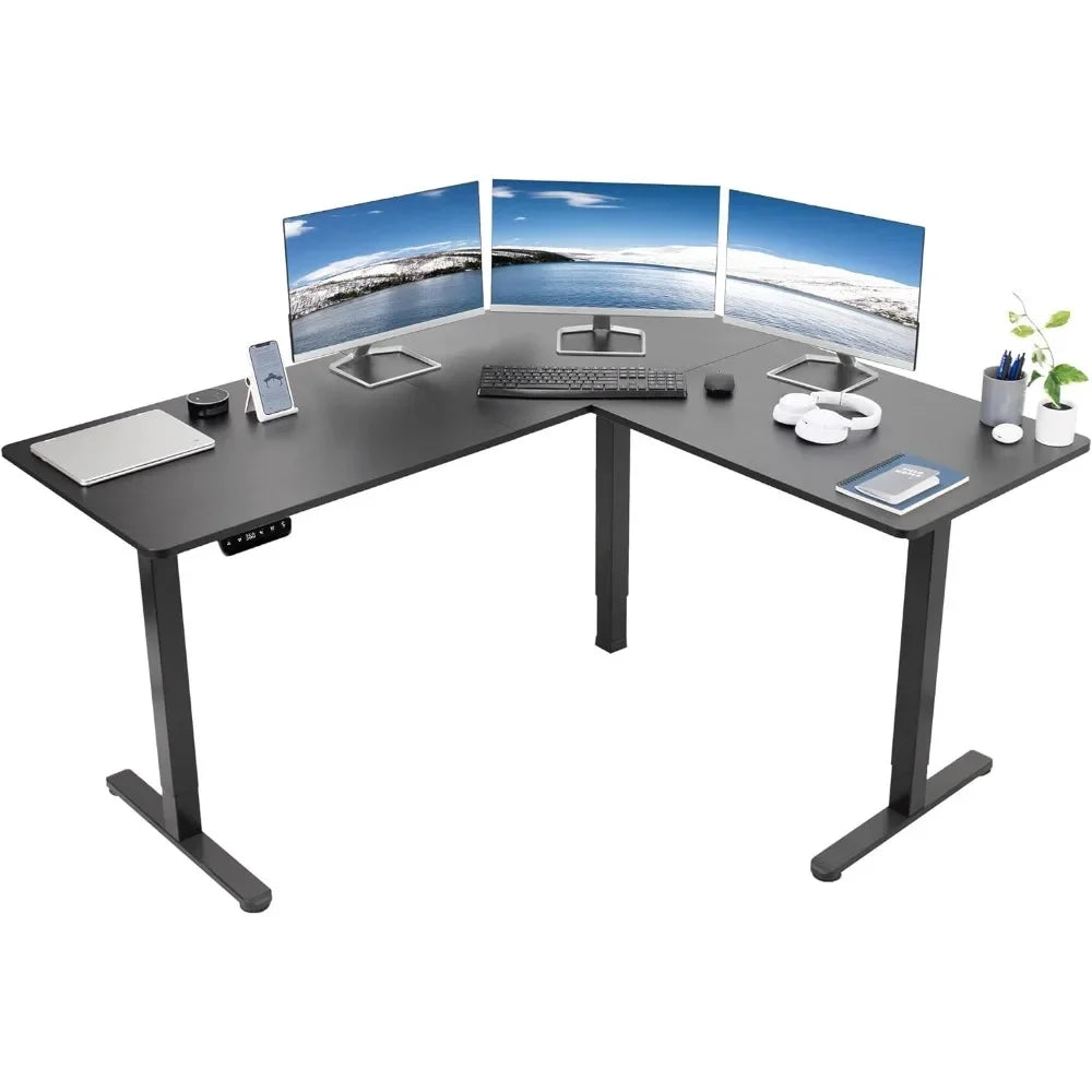 The Electric Height Adjustable 63 x 55 Inch Corner Stand Up Desk features three monitors, a keyboard, mouse, smartphone, coffee cup, headphones, stationery, and a potted plant—all arranged for a clean and organized workspace.
