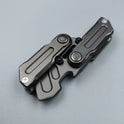 A Fidget Magnetic Coin EDC Adult Decompression Toy, a multifunctional crowbar fidget slider spinner for anxiety and stress relief, lies closed on a light gray surface, displaying quality metal construction and CE Certification.
