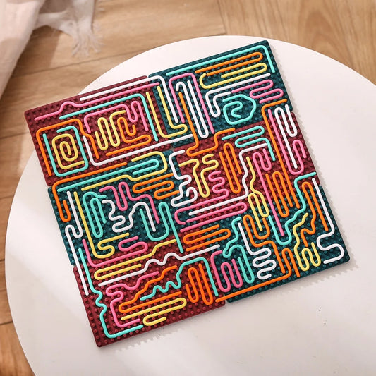 The Silicone Montessori Sensory Activity Board Fidget Toy for Kids features a colorful, square silicone design with a raised maze pattern—ideal for anxiety relief and mindfulness.