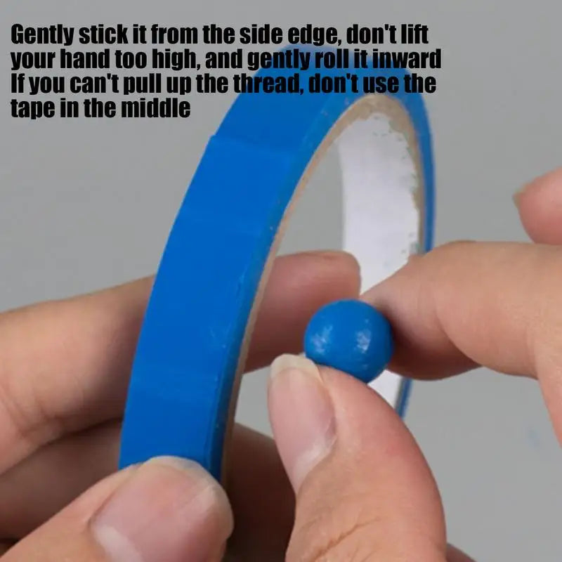 A hand holds a roll of Sticky Toys For Kids blue tape, while another holds a sticky blue ball—fun sensory toys for all ages. Usage instructions are written in black at the top of the image.