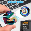 A hand holds the Infinity Gear Cube Spinner Antistress Toy in front of a laptop. Text highlights its NEW BOOST VERSION, crafted from 100% stainless steel with quality workmanship from Mainland China.