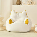 A beige Premium Teddy Velvet Bean Bag Sofa Cover for Indoor Lounging, shaped like a cat, adds comfort and style as plush toy storage or seating in a cozy, modern room with minimalist decor.