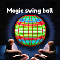 A pair of hands hovers beneath a glowing Magic Flying Ball Mini Toy—an automatic obstacle avoidance UFO boomerang spinner for adults and kids—with intersecting neon-red, green, yellow, and blue lines on a dark background.