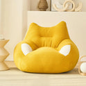 A cozy, yellow Premium Teddy Velvet Bean Bag Sofa Cover for Indoor Lounging sits in a modern, minimalistic room with beige decor and soft natural light.