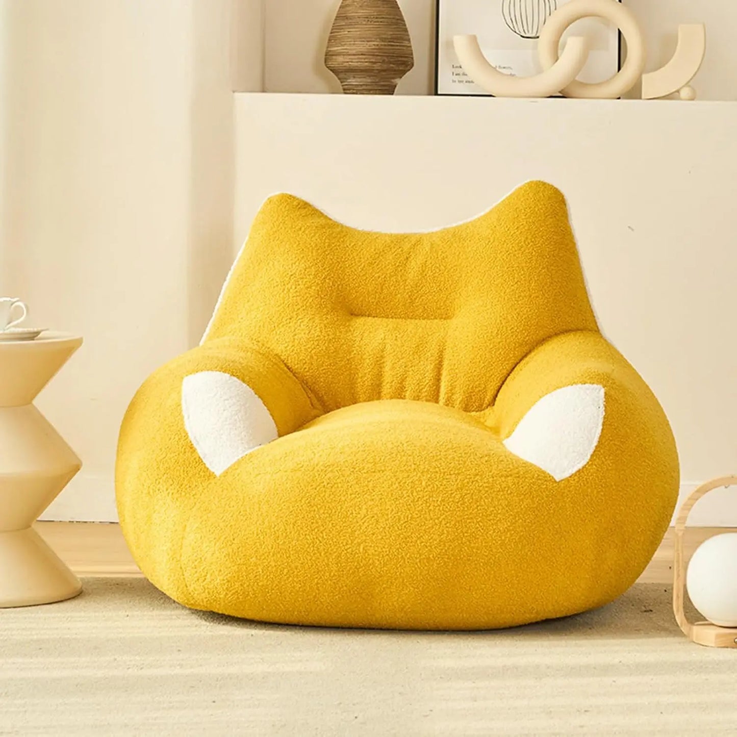 A cozy, yellow Premium Teddy Velvet Bean Bag Sofa Cover for Indoor Lounging sits in a modern, minimalistic room with beige decor and soft natural light.