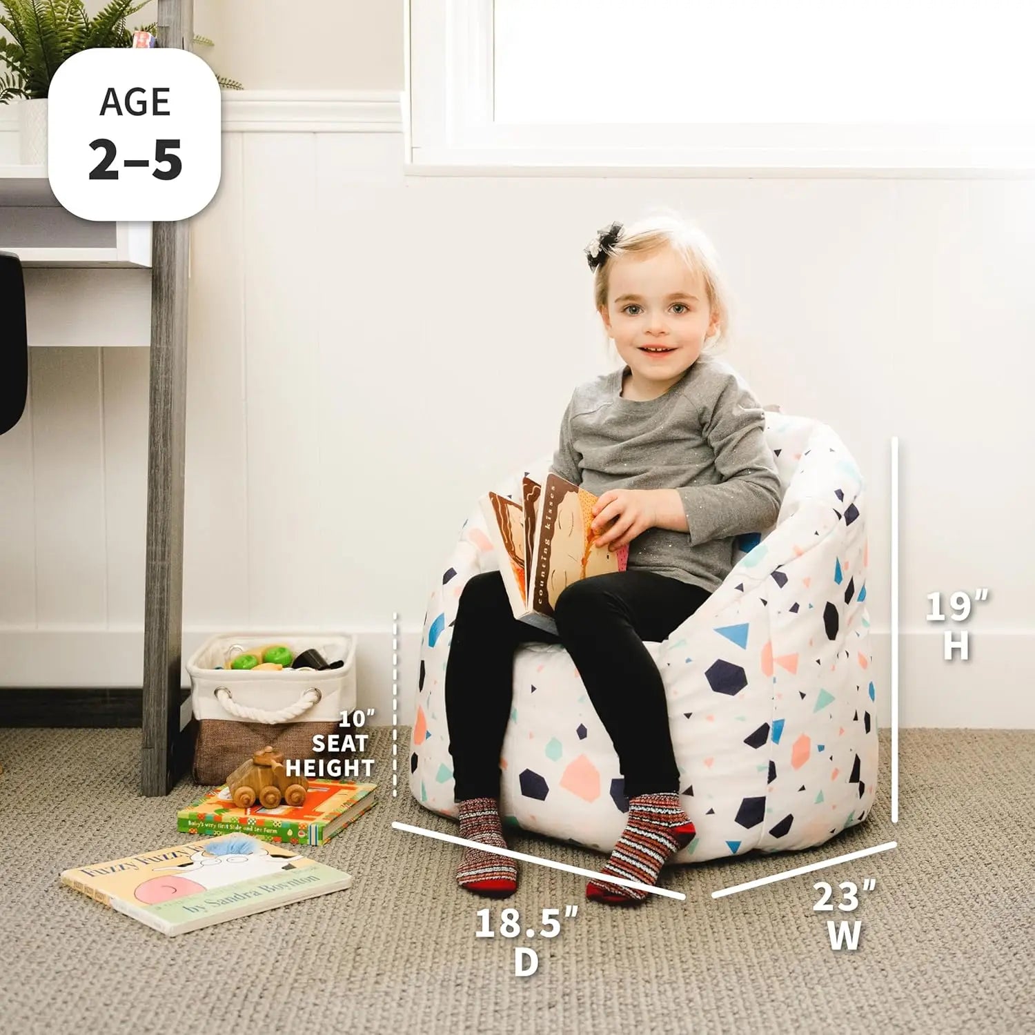 A young child sits in the Milano Kids Bean Bag Chair for Comfort and Fun, reading a book. Measuring 19H x 23W x 18.5D with a 10 seat height, it’s durable and perfect for ages 2–5, fitting any playroom.
