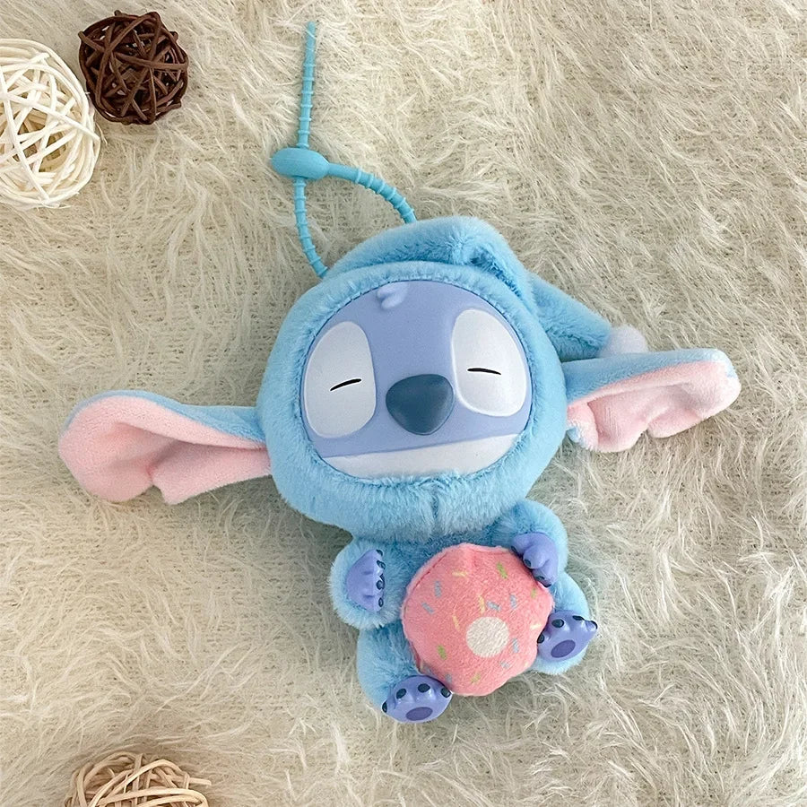 The Kawaii Accessories Stitch Plush Toy Lilo and Stitch Keychain features Stitch holding a pink donut, lying on a beige rug with wicker balls nearby—a cute Eat Something Before Sleep series backpack pendant for girls.