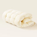 Thick Padded Play Cushion in cream, shaped as a rectangular tufted cushion folded in half to serve as a play mat.
