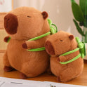 Two Cute Turtle Backpack Capibara Strawberry Hat Capybara Plush Toys sit side by side on a wooden surface, with a blurred green plant behind—adorable stuffed animals and the perfect birthday gift or decor for kids.