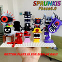 A hand displays the white New Moc Incredibox Sprunki Building Blocks Set, featuring colorful horror anime monster figures with sharp teeth and big eyes, perfect as a music game toy or gift for birthdays and Christmas. Blurred living room background.