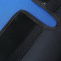Close-up of blue and black fabric with textured stitching and a hook-and-loop fastener, part of the Sensory Compression Vest for Kids—soft, breathable pressure vest for children with autism, hyperactivity, or mood disorder.