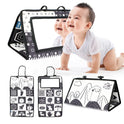 A baby crawls on the Crinkle Cloth Book Visual Stimulation Toy, a black-and-white mat with a mirror, ideal for sensory exploration. It showcases animal and shape patterns to boost visual development, with images of both front and back views.