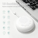 The 10 Songs White Noise Sound Machine, a portable baby sleep machine with volume control and rechargeable battery, sits by a laptop. Icons show 10 soothing sounds: white noise, birds, heartbeat, waves, lullabies, streams, clock, and cricket.