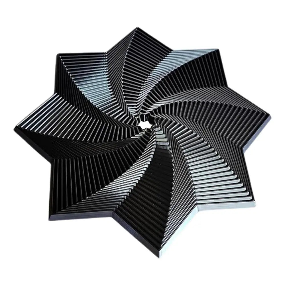 The Fidget 3D Spinner Stress Relief Toy, colored black, features a geometric star shape with a spiraling layered pattern that creates a striking 3D optical illusion. Made of rubber and ideal for stress relief or sensory party games. Crafted in Mainland China.