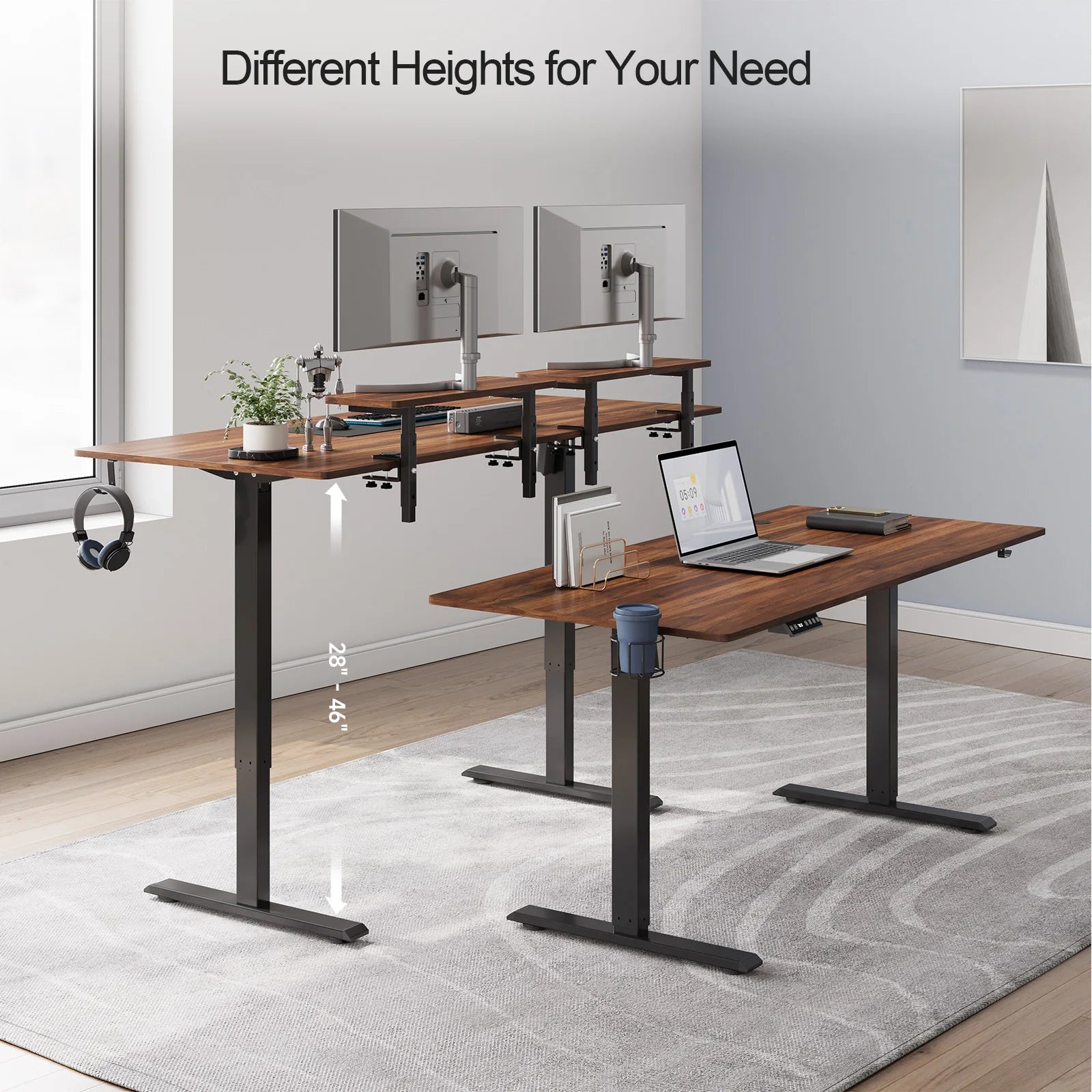 A modern office with two Standing Desks w/ 2 Adjustable Monitor Shelves Electric Stand Up Desk, each supporting monitors, laptops, and accessories. One desk is elevated to highlight its 28–46 height range amid minimalist decor.