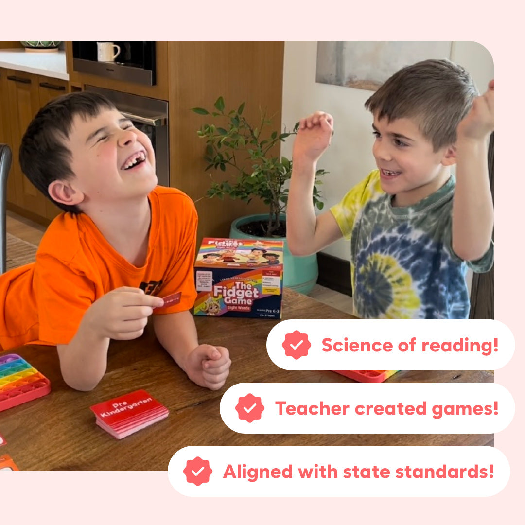 Two children laugh and play with the Kindergarten Learning Bundle, using educational math and sight word card games at a wooden table.