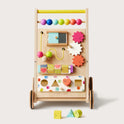 The Tiny Land® Premium Natural Wooden Activity Walker for toddlers includes colorful beads, gears, sliding blocks, a bead maze, and shape-sorting holes with matching blocks placed in front.