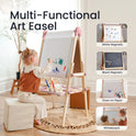 A child sits on a stool painting at a Magnitales Double-Sided Art Easel with Paper Roll, which features a paper roll, a magnetic whiteboard, and a magnetic chalkboard.