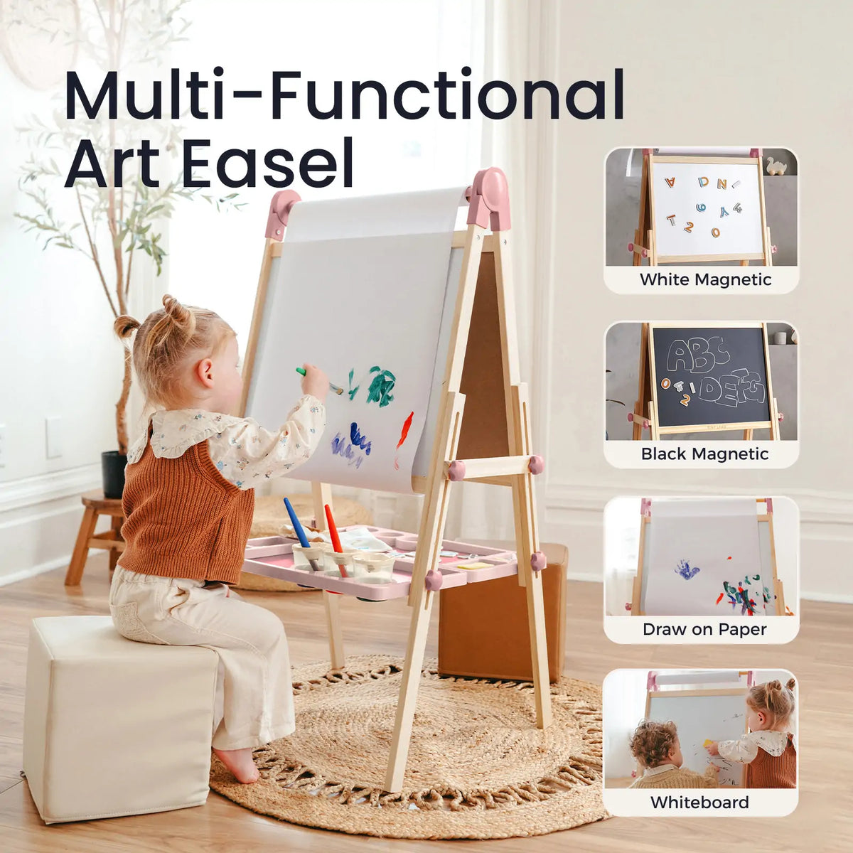 A child sits on a stool painting at a Magnitales Double-Sided Art Easel with Paper Roll, which features a paper roll, a magnetic whiteboard, and a magnetic chalkboard.