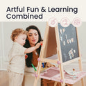 A toddler and an adult play with magnetic letters on a Magnitales Double-Sided Art Easel with Paper Roll.