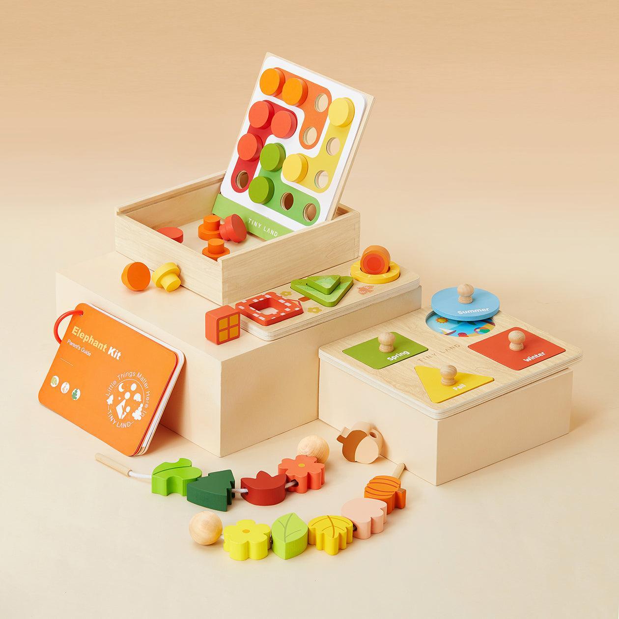 Tiny Land® Montessori Toys for Toddlers (18–24 Months) features colorful sorting boards, shape puzzles, stacking pieces, and a beaded lacing string, all arranged on light wooden boxes against a beige background.