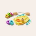 The Tiny Land® Montessori Toys for Toddlers (16–18 Months) set features colorful wooden rings, a yellow gingham drawstring bag, and pegs—perfect as an educational toy inspired by the Montessori Learning Box method.