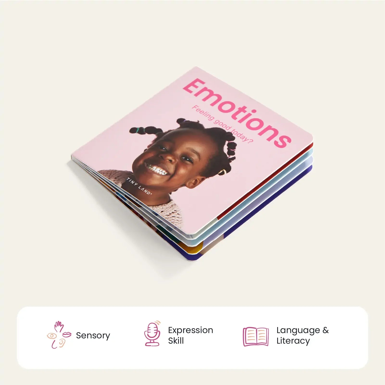 A children's board book, Emotions, featuring a smiling young girl on the cover is shown with icons for Sensory, Expression Skill, and Language & Literacy—an ideal companion to Tiny Land® Montessori Toys for Infants (10–12 Months).