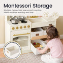 A toddler explores the Tiny Land® Wooden Play Kitchen with Storage, opening labeled drawers filled with pretend cookware and toys for organized, educational play.