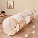 An Adventure Crawl Tunnel (68″) in brown and white, featuring a star pattern, a cylindrical shape, and plastic balls inside and scattered on the floor.