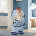 A young boy stands inside a blue Adventure Crawl Tunnel (68″) decorated with white stars.