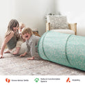 Three children play near a long, floral-patterned Adventure Crawl Tunnel (68″) on the floor.