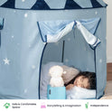 A child sleeps inside a light blue Starry Indoor Play Tent for Toddlers decorated with white stars, beside a glowing lamb-shaped nightlight.