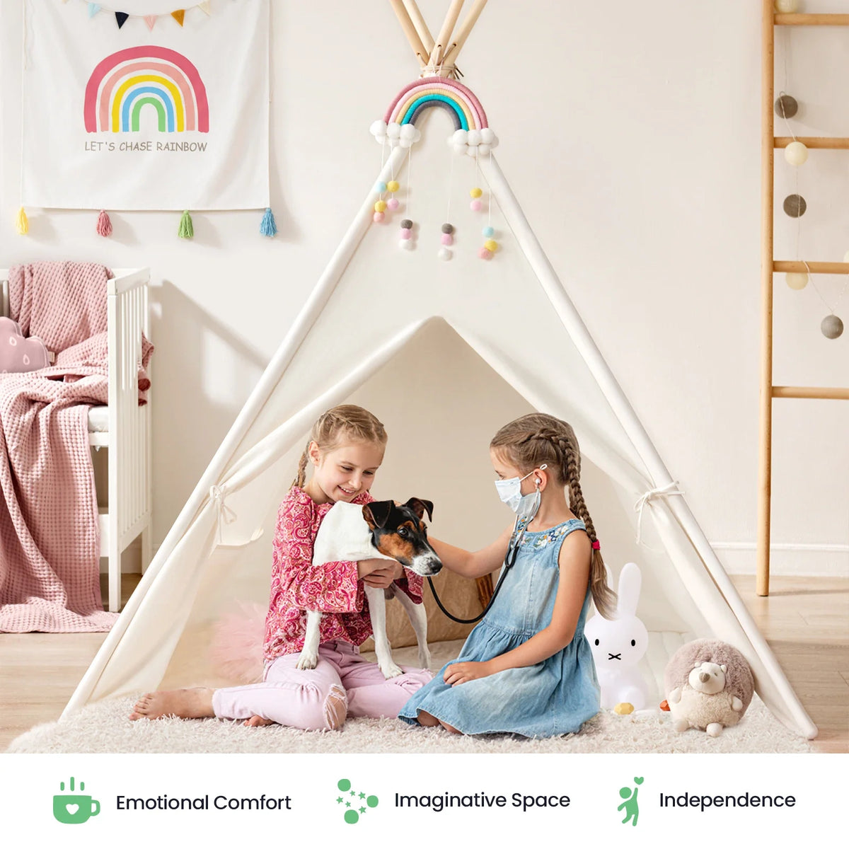 Two girls sit in front of a white Cozy Kids Teepee Tent with Padded Mat, with one girl using a toy stethoscope to examine a small dog.