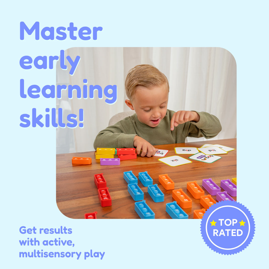 A young boy uses Grade 1 Complete Skills Bundle plastic building blocks and word cards at a wooden table, with text overlays reading Master early learning skills! and Get results with active, multisensory play.