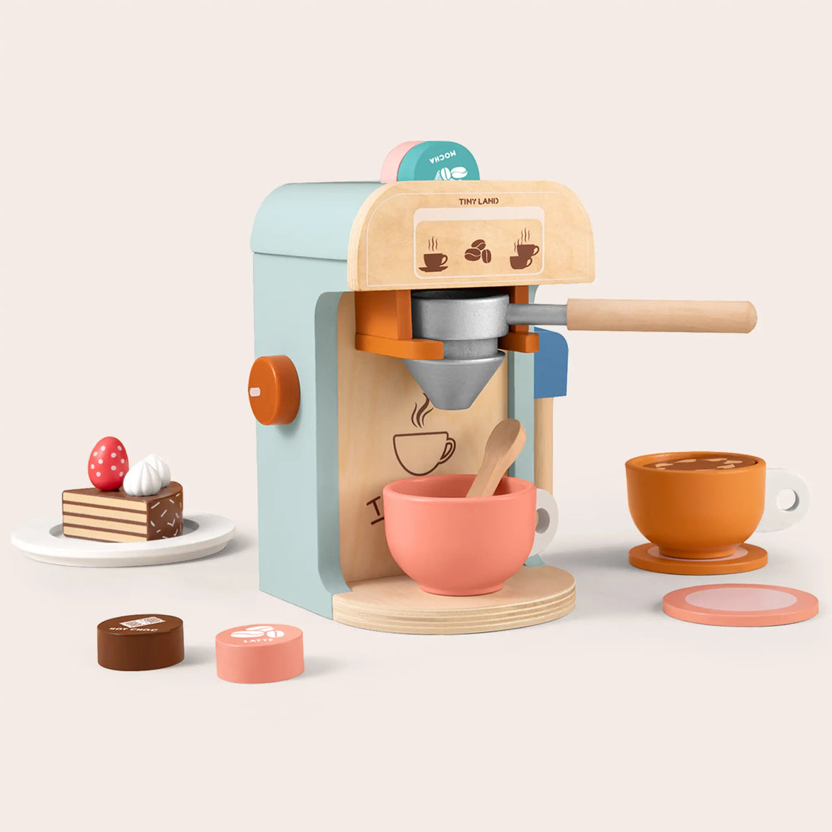 Wooden Play Coffee Maker Set with a portafilter, a coral cup, a slice of cake on a plate, and small drink-labeled discs.
