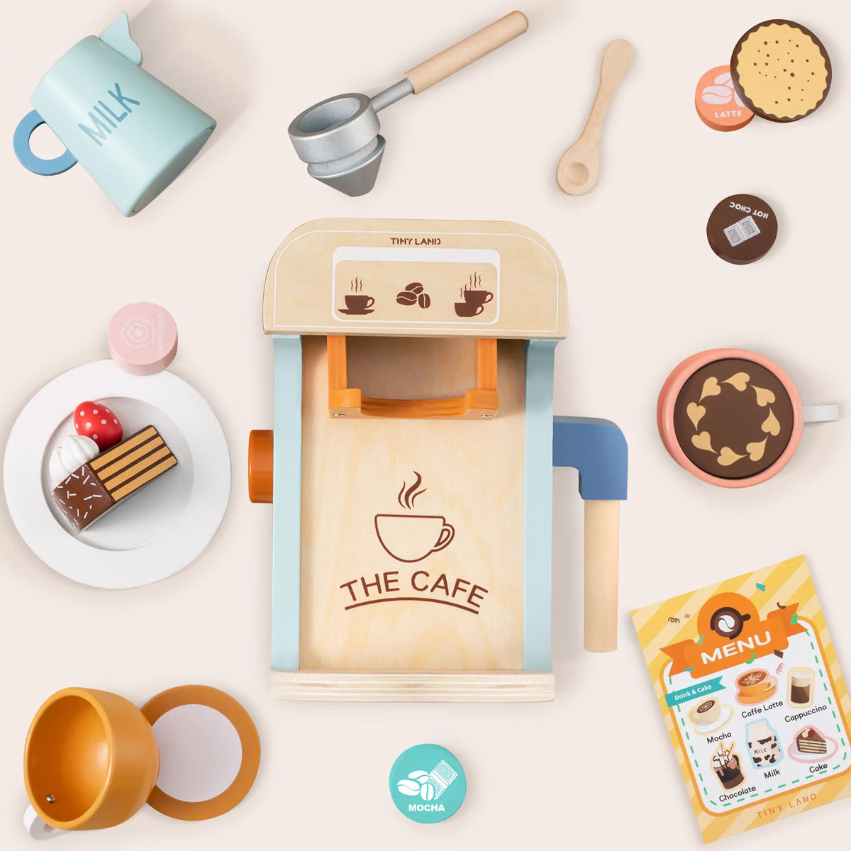 A Wooden Play Coffee Maker Set featuring a toy coffee maker, pitcher, saucer with cake, cups, spoon, coffee-themed tokens, and a menu.