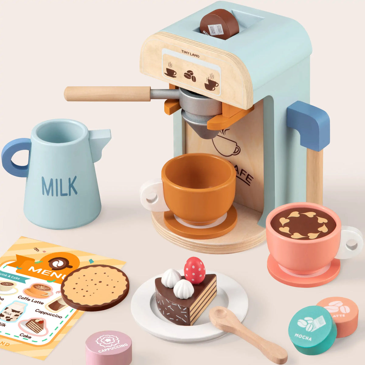 Wooden Play Coffee Maker Set featuring a toy coffee maker, milk pitcher, two cups, a slice of cake, a cookie, coffee pods, and a menu card.
