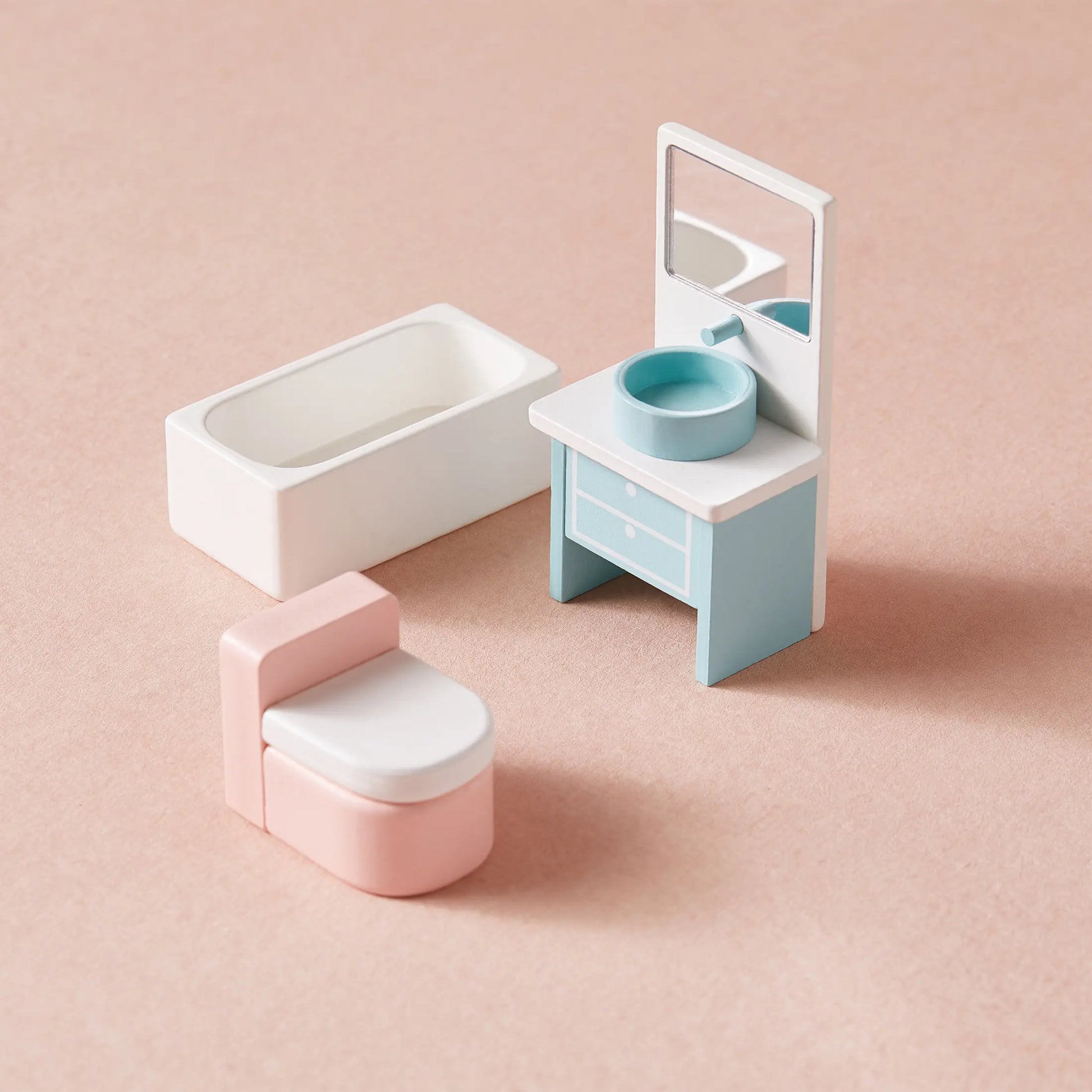 Miniature bathroom set for imaginative play, featuring a white bathtub, pink and white toilet, and blue and white vanity—ideal for the Tiny Land® Sweetwood Love Dollhouse without Dolls and classic toy collections.