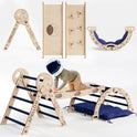 A young child wearing an astronaut helmet climbs on the Apollo 4in1 Climbing Set—which includes a Pikler triangle, arch, slide board, and star-patterned cushion—creating an out-of-this-world play space for little explorers ages 1–3 who love toddler climbing toys.