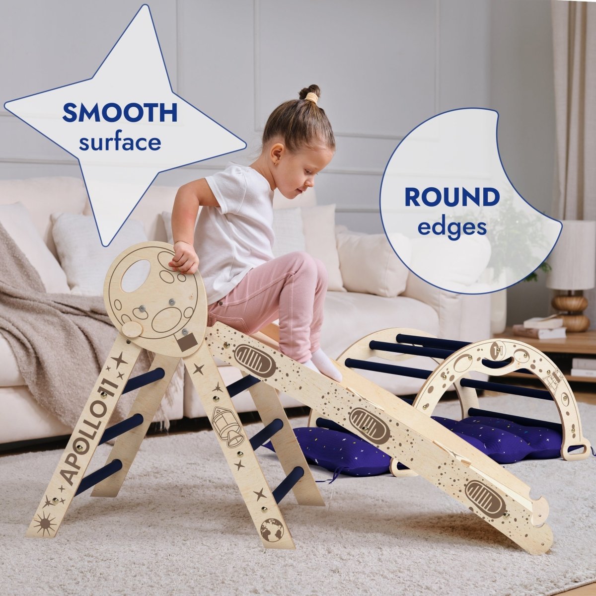 A young child plays on the Apollo 4in1 Climbing Set: Pikler Triangle, Arch, Slide Board, and Cushion for Little Toddlers Astronauts (1–3 Years), a Montessori climbing set with space-themed designs. Text highlights the smooth surface and round edges of these toddler climbing toys. A beige couch and a rug are in the background.