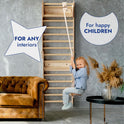 A young girl swings on the Apollo Swedish Wall / Climbing Ladder for Little Astronauts with Moon Swing Set and Slide Board in a stylish living room. Text: Perfect for any interior—create a fun home sports corner your kids will love!.