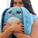 A person holds a Bo the Moon Pal – 5 lb Weighted Plush, an ultra-soft blue rabbit with long ears, large eyes, and a star emblem on its belly.