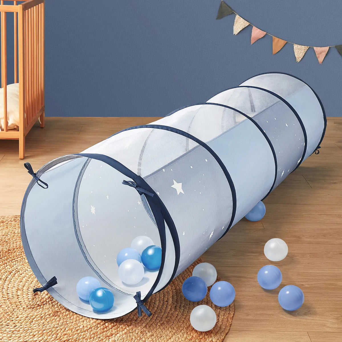 Blue Adventure Crawl Tunnel (68″) decorated with stars, with several blue and white play balls inside and around this kids adventure tunnel.