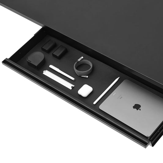 An Under Desk Drawer in black is open, neatly organizing a tablet, stylus, charging cable, AirPods, power adapter, batteries, and pens in separate compartments for efficient under desk storage.