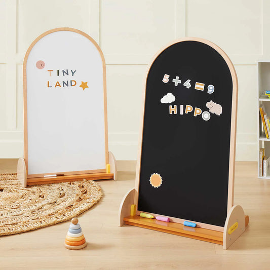 An Arched Double-Sided Magnetic Chalkboard Easel featuring two arched beechwood easels, one with a white board and one with a magnetic chalkboard, decorated with educational magnets and colored chalk.