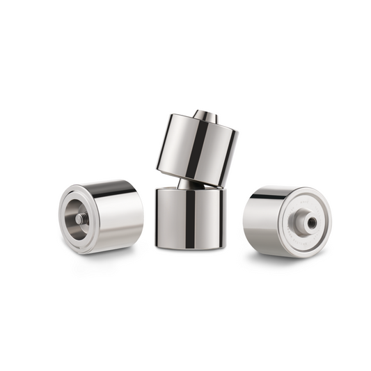 Three shiny, stainless steel Hexcal Studio Extension Kit pieces are upright and angled on a white background. Two reveal flat faces—one with a threaded hole—while the third tilts atop, perfect for an ergonomic desk setup.