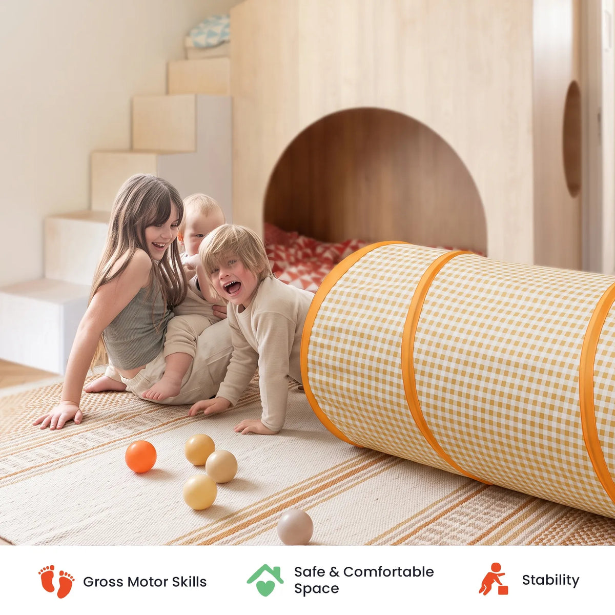 Three children playing with an Adventure Crawl Tunnel (68″) in yellow and white gingham and several small balls on a rug.
